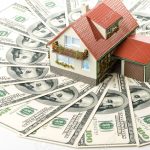 3360761-Miniature-House-and-Money-Buying-house-concept-Stock-Photo